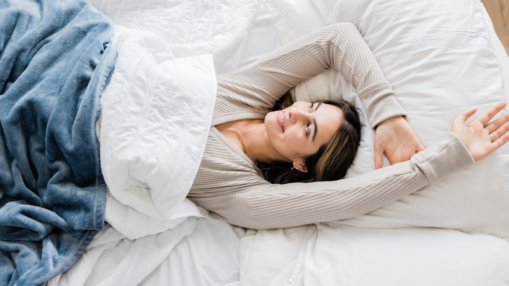 woman waking up happy after sleeping on a firm mattress
