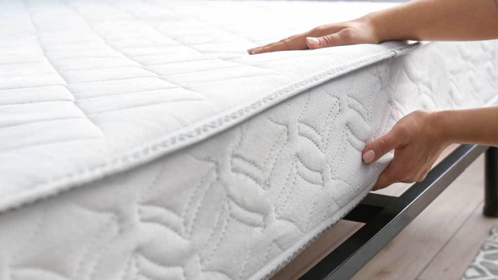 person lifting mattress to flip and rotate
